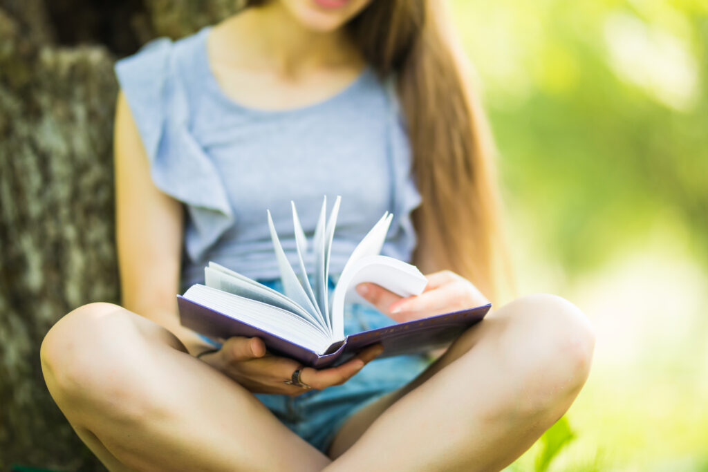Woman reading educational content in a park